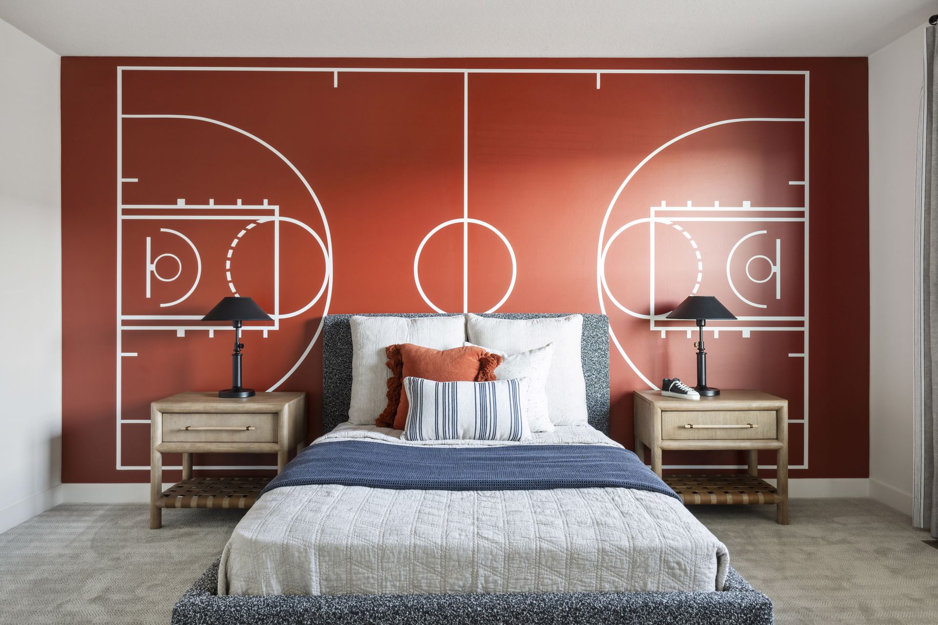 http://Illustrated%20basket%20ball%20court%20mural%20on%20the%20wall%20behind%20a%20bed%20in%20a%20room%20decorated%20for%20basketball%20fans