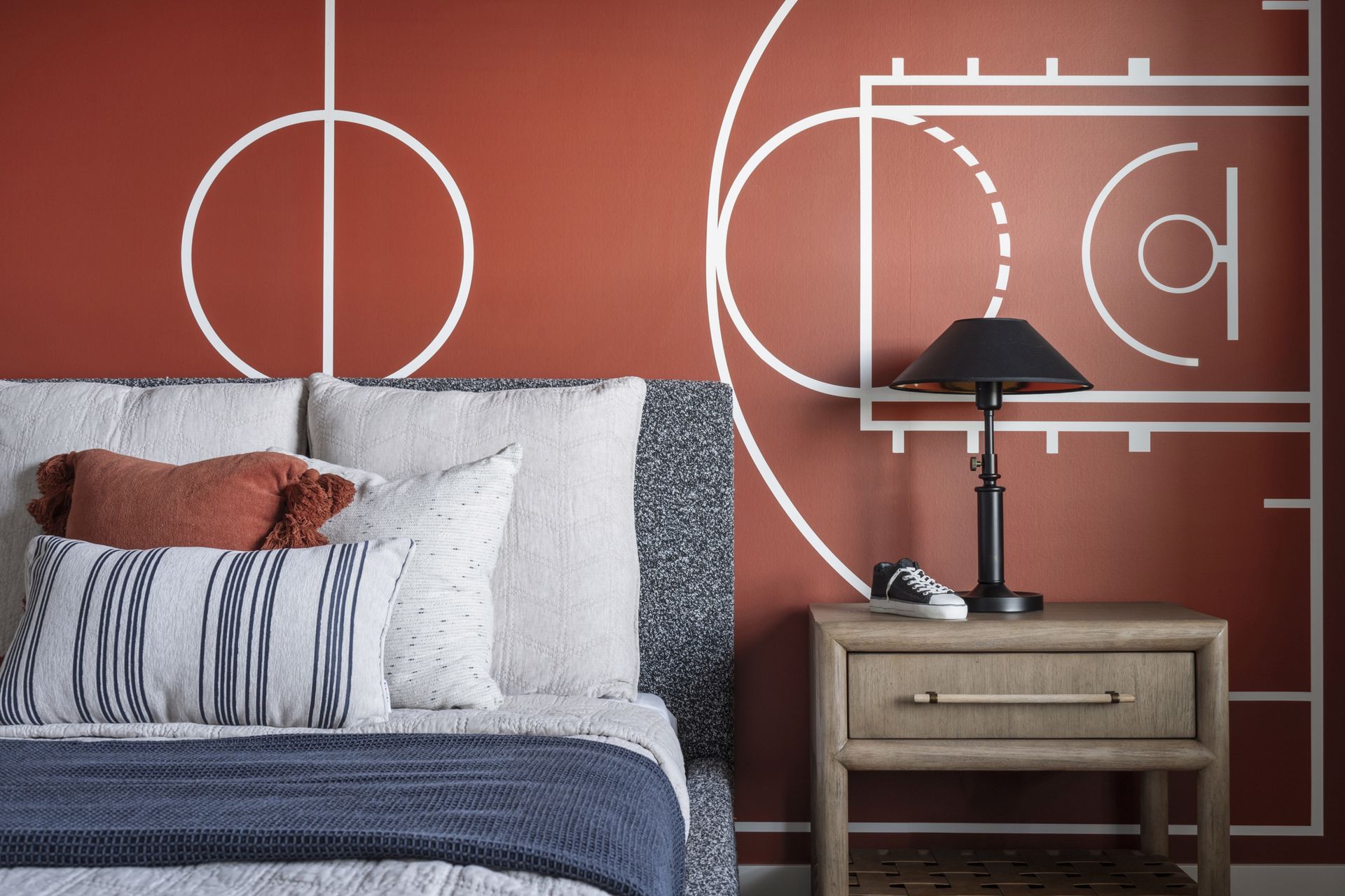 http://Close%20up%20of%20a%20portion%20of%20the%20basketball%20mural,%20nightstand%20and%20bed%20in%20a%20room%20decorated%20for%20basketball%20fans